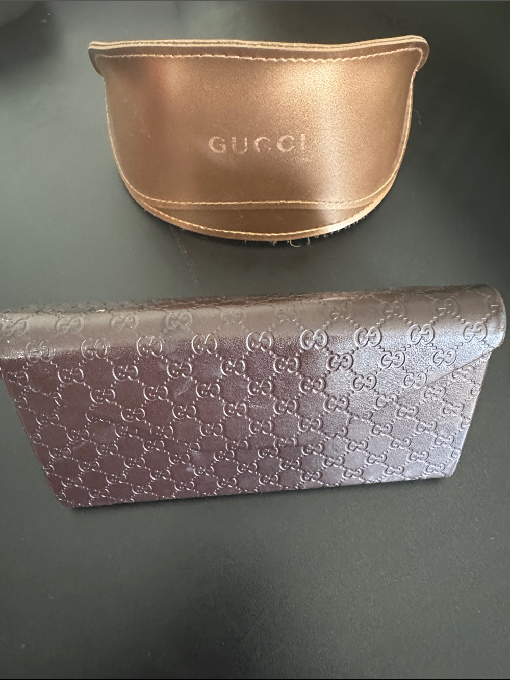 2 Gucci Embossed and Sunglass Cases, 1 hard brown and 1 engraved gold case